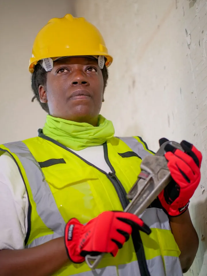 Plumbing professional in protective gear, tankless water heater installation Fort Myers