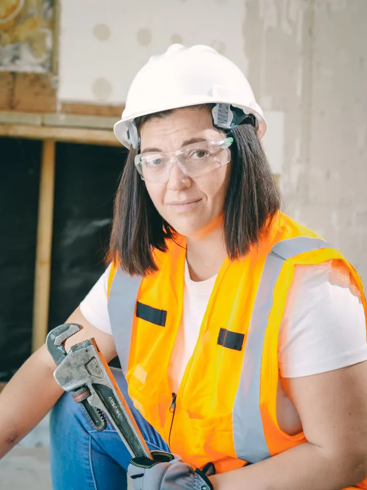 Technician holding a wrench on a job site, water heater installation Fort Myers